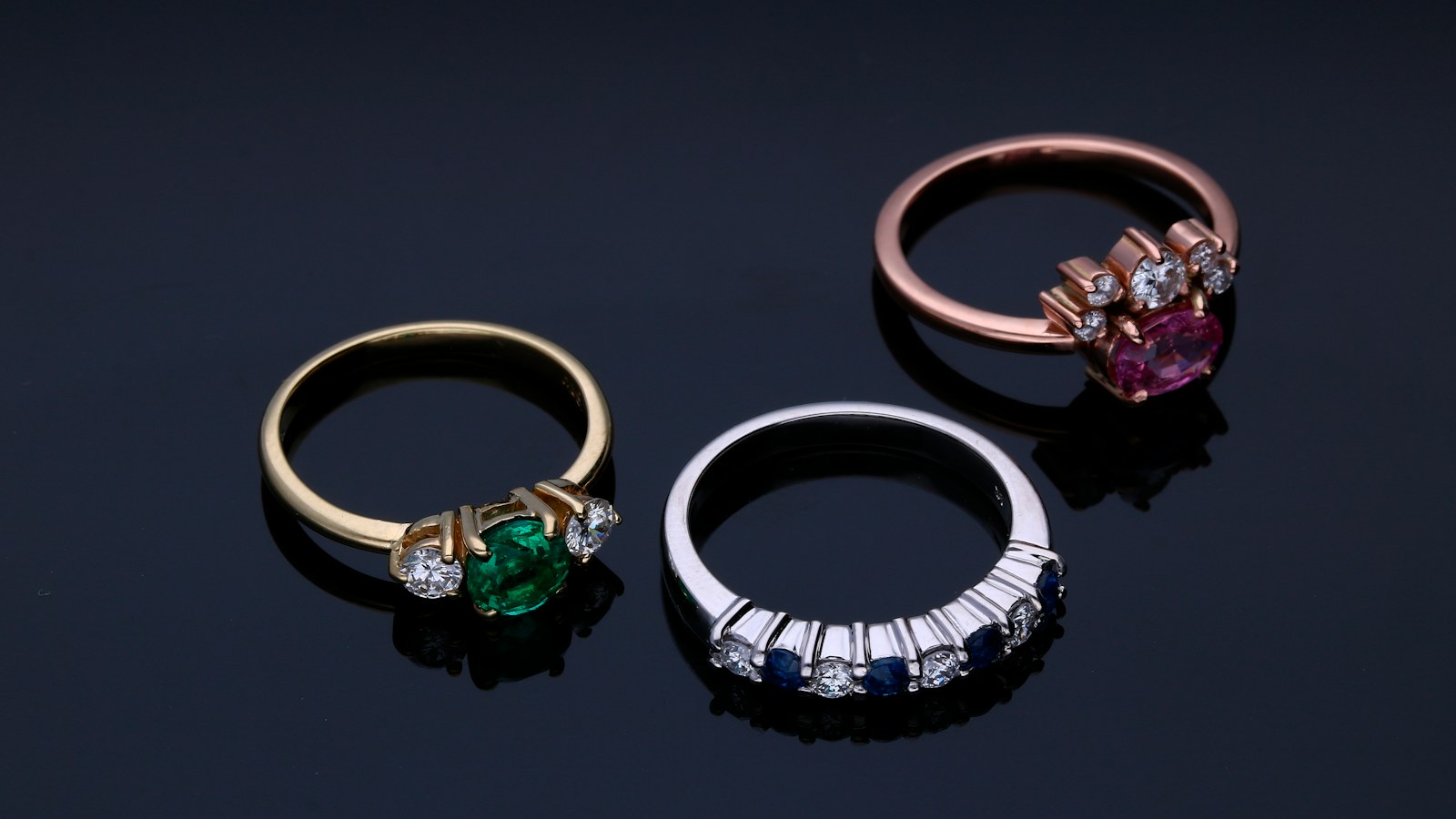 Patent Lawyer for Jewelry and Accessories | Schell IP | Schell IP: Premier Patent Law Support Jewelry rings with decorative settings on a dark background