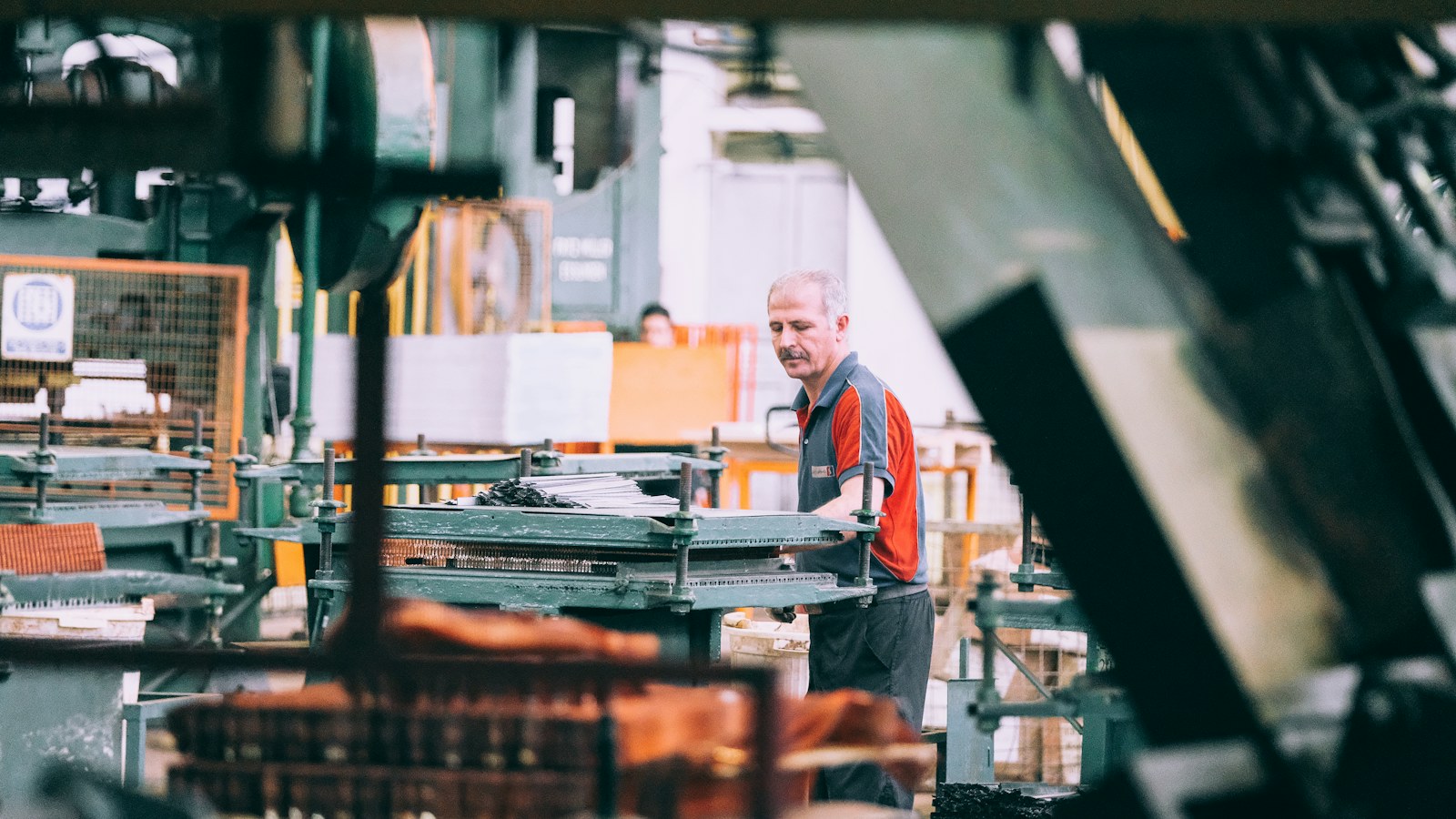Manufacturing worker operating industrial machinery in a factory