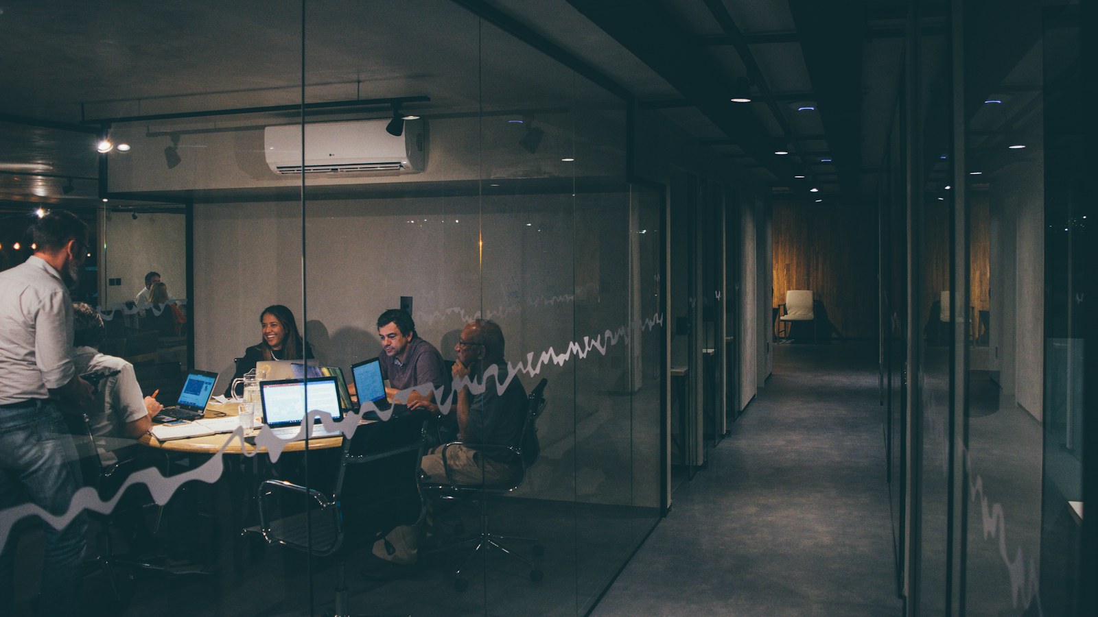 Patent Lawyer for Mergers and Acquisitions | Schell IP | Schell IP: Premier Patent Law Support | Schell IP: Premier Patent Law Support Business participants reviewing documents at a meeting