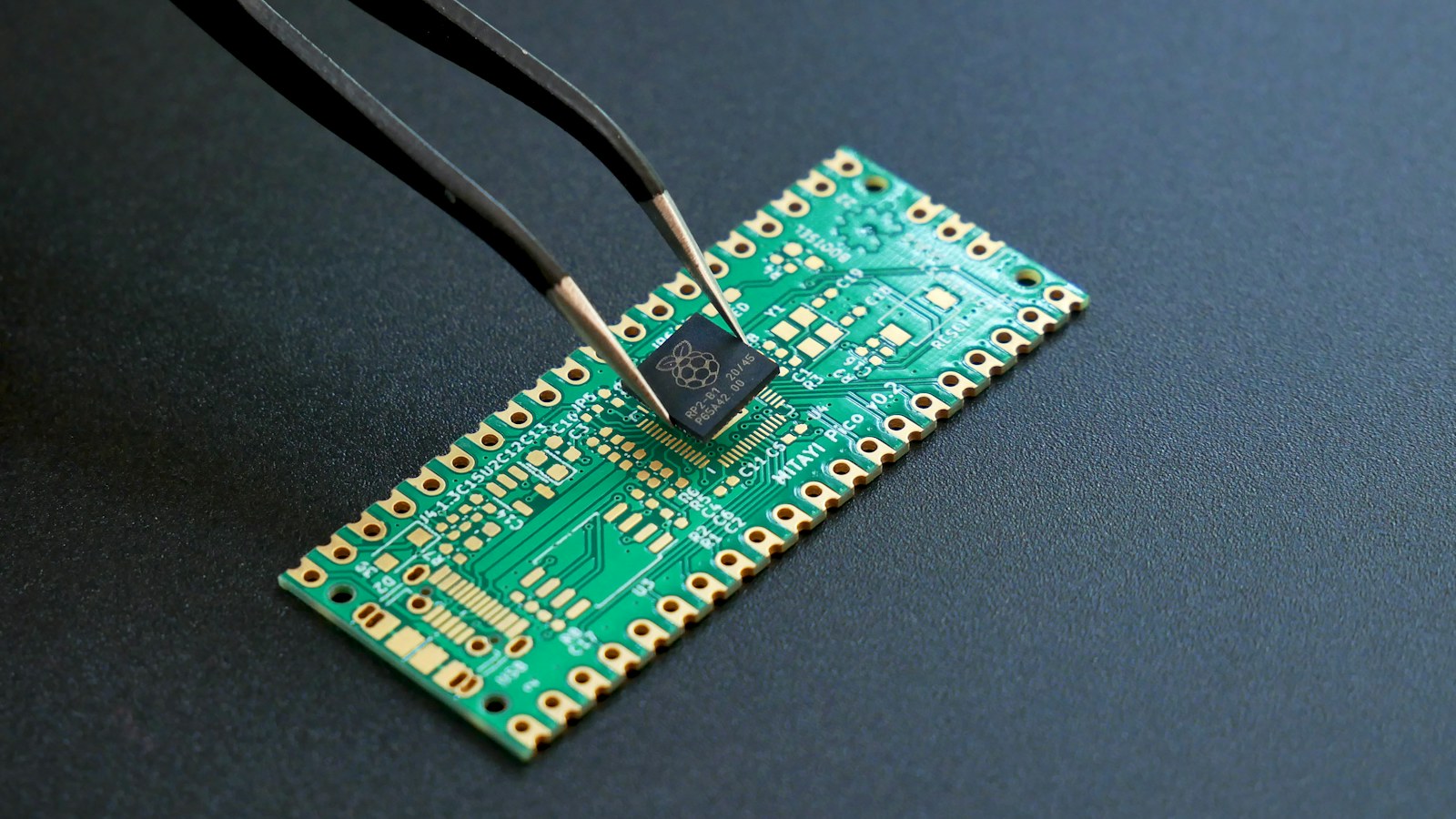 Microcontroller held above a printed circuit board