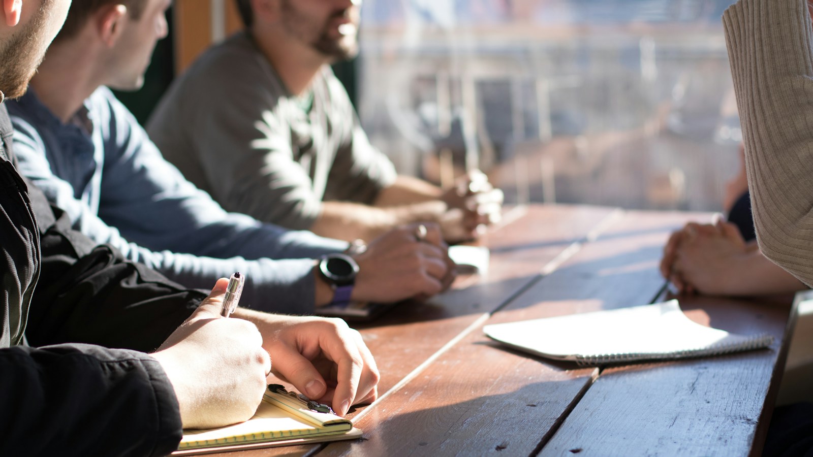 Product builders collaborating around a meeting table